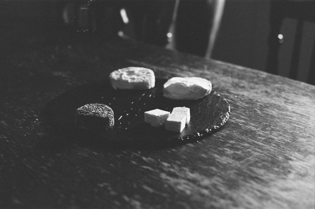 A cheeseboard photographed on Tri-X film