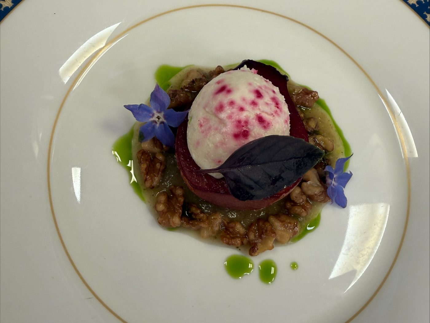 Smoked St Tola goat's cheese ice cream on merlot poached pear with candied walnuts, pickled shallot and borage flowers