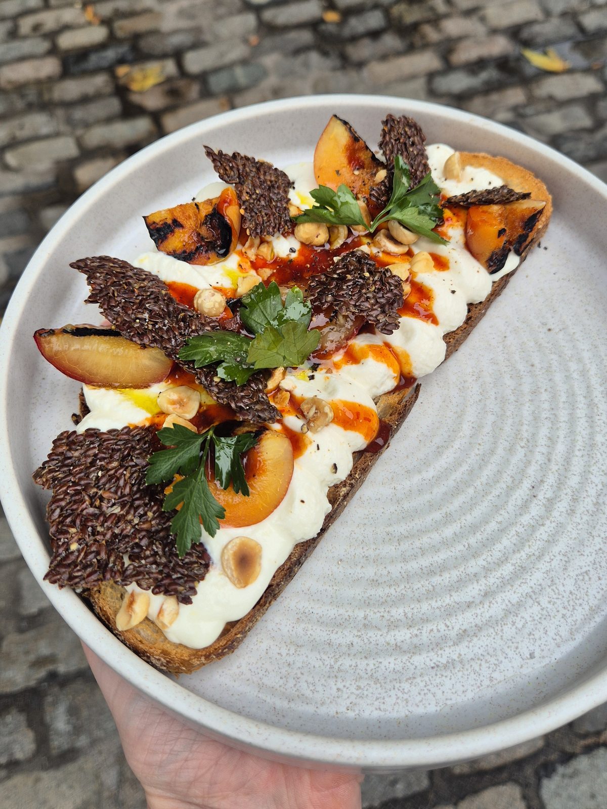 Whipped St Tola goat's curd with hot honey, hazelnut and linseed on sourdough